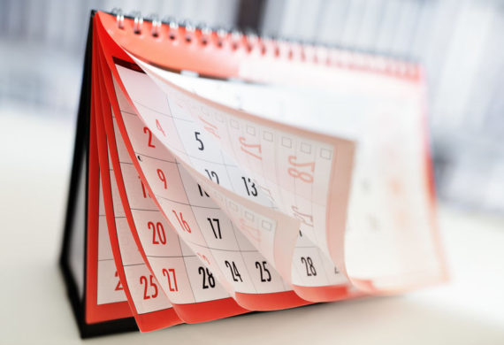 Desk calendar with pages curled and flipping up showing the months of pages